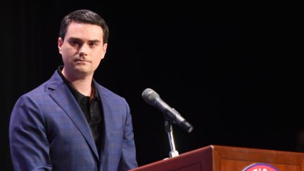 ben Shapiro standing in front of a microphone