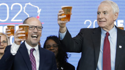 Milwaukee Mayor Tom Barrett (R) and Chair of the Democratic National Committee Tom Perez toast with a beer during a press conference at the Fiserv Forum in Milwaukee, Wisconsin on March 11, 2019, to announce the selection of Milwaukee as the 2020 Democratic National Convention host city.