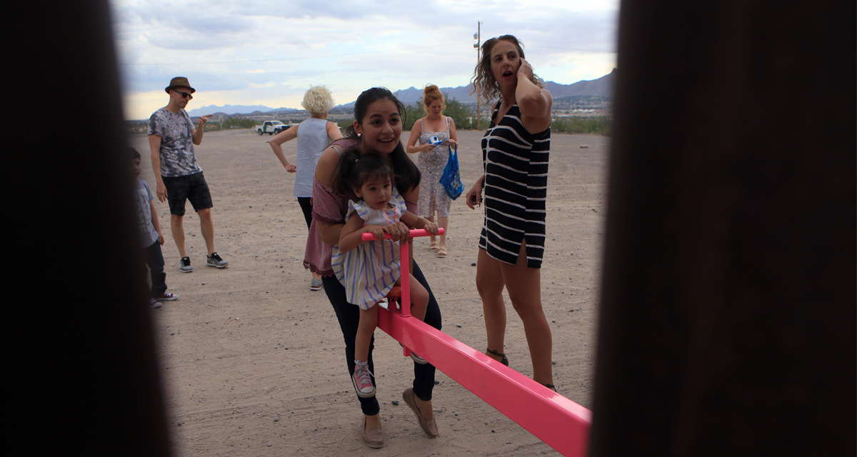 American and Mexican families play with a toy called "up and down" (Seesaw swing) over the Mexican border with US at the Anapra zone in Ciudad Juarez, Chihuahua State, Mexico on July 28, 2019.