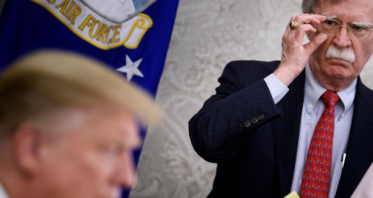 National Security Advisor John R. Bolton listens while US President Donald Trump speaks to the press before a meeting with Hungary's Prime Minister Viktor Orban in the Oval Office of the White House on May 13, 2019, in Washington, DC.