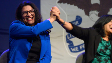 Rep. Rashida Tlaib high-fives Rep. Pramila Jayapal