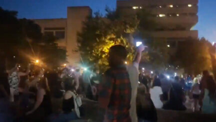 Citizens gathered in Jefferson Square Park in Louisville to remember Breonna Taylor raise their cell phones as they sing along to We Are The World.