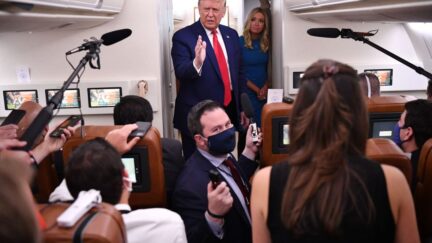 A maskless President Donald Trump addresses reporters on Air Force One