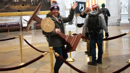 Adam Johnson, looting House Speaker Nancy Pelosi's lectern from Capitol