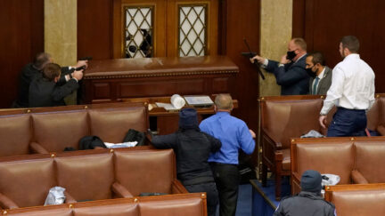 Capitol Police point their guns at rioters trying to breach door to House floor