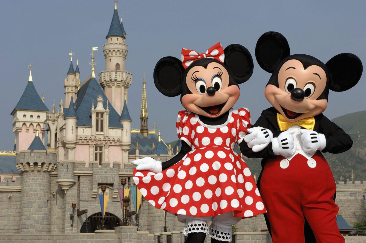 Minnie and Mickey Mouse in front of Disney castle