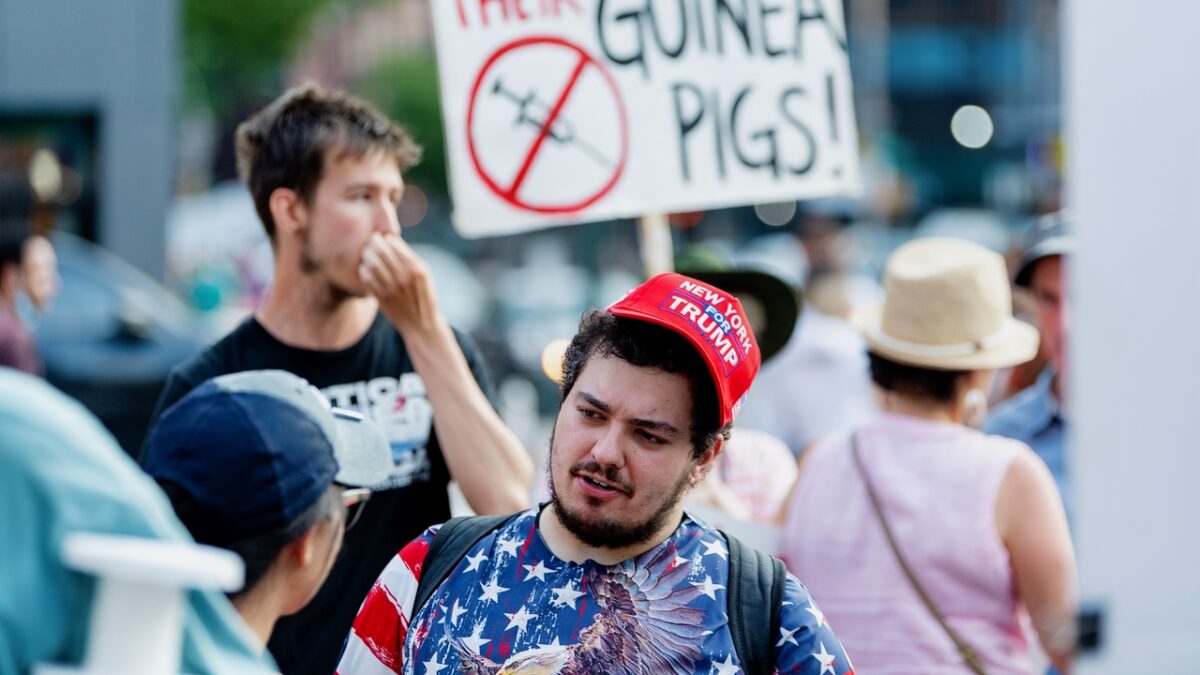 NEW YORK, NEW YORK - JUNE 20: An anti- vaccination activist wears a "New York for Trump" hat as they protest the proof of vaccination requirement to get in to get into the Foo Fighters show as Madison Square Garden reopens with the first full capacity concert since March 2020 on June 20, 2021 in New York City. (Photo by Roy Rochlin/Getty Images)