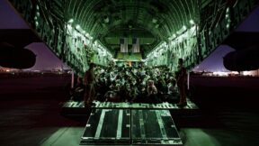 KABUL, AFGHANISTAN - AUGUST 21: In this handout provided by the U.S. Air Force, an air crew assigned to the 816th Expeditionary Airlift Squadron assists evacuees aboard a C-17 Globemaster III aircraft in support of the Afghanistan evacuation at Hamid Karzai International Airport on August 21, 2021 in Kabul, Afghanistan.