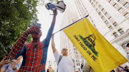 NEW YORK, NEW YORK - AUGUST 25: A man dressed as Spiderman and a man holding a Don't Tread on Me flag protest with the NY Unions for Choice against vaccine mandates at City Hall on August 25, 2021 in New York City. After the U.S. Food and Drug Administration's approval of Pfizer's Covid-19 vaccine, which had been previously made available to the public for emergency-use only, mandates are becoming more widespread, as are protests.