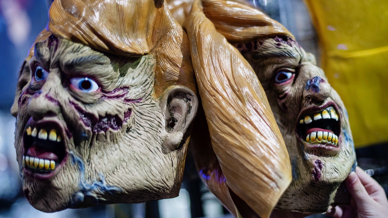 PHILADELPHIA, PA - OCTOBER 28: A boy reaches for a zombie themed President Donald Trump mask on the day before Halloween on October 30, 2020 in Philadelphia, Pennsylvania. With the election only four days away, this new form of in-person voting by using mail ballots, has enabled tens of millions of voters to cast their ballots before the general election. President Donald Trump will hold four rallies throughout Pennsylvania tomorrow to bolster his reelection prospects.