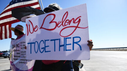 People display signs at the Tornillo Port of Entry near El Paso, Texas, June 21, 2018 during a protest rally including several American mayors against the US administration's family separation policy.