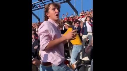 LSU fan protects his sunglasses during crowd fight