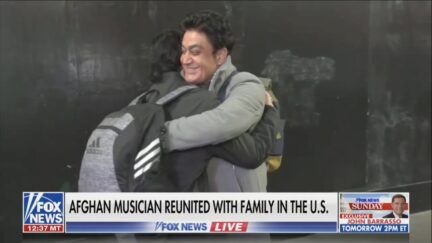 Ahmad Fanoos hugs his son