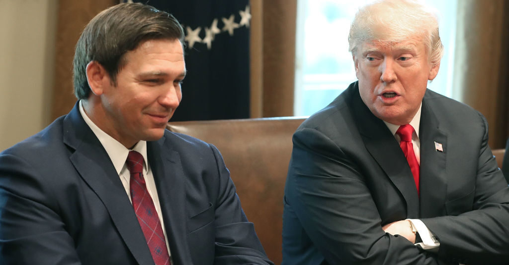 ron DeSantis at table with donald trump