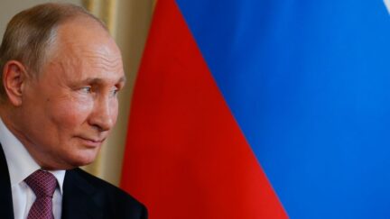 Vladimir Putin in front of Russian flag