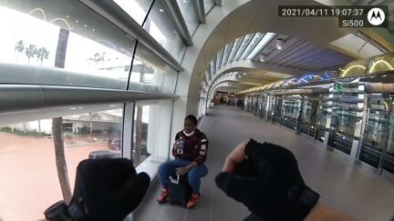 Chelsea Alston rides a suitcase through Orlando airport