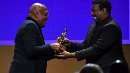 Samuel L Jackson accepting honorary Oscar from Denzel Washington