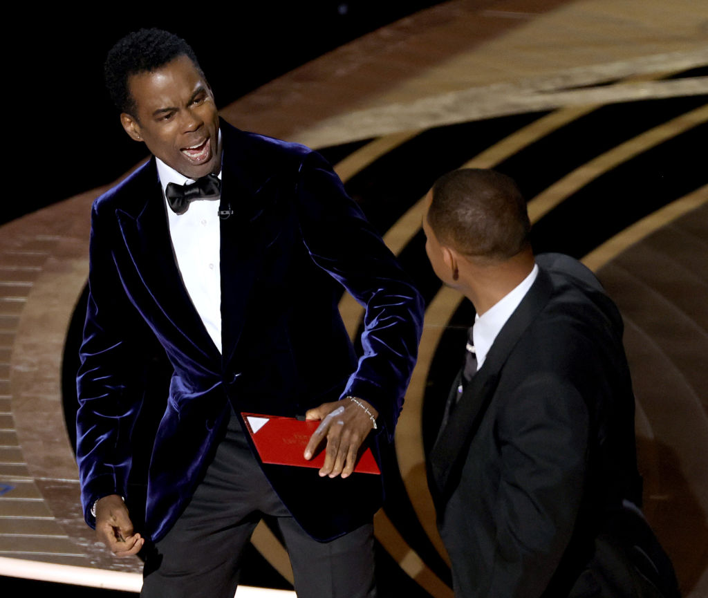 Chris Rock reacts to Will Smith slapping him at the Oscars