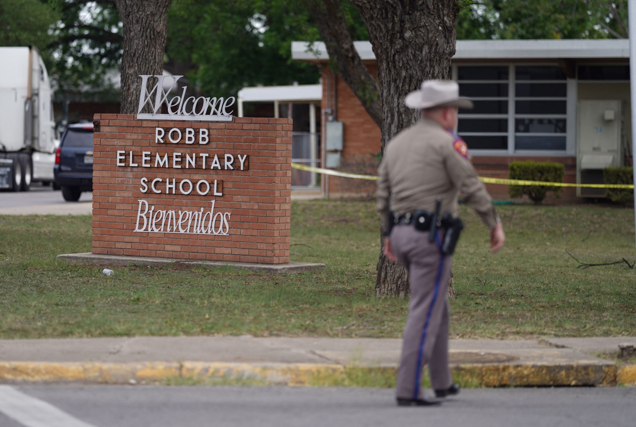 An officer walks outside of Robb Elementary School in Uvalde, Texas, on May 24, 2022. - An 18-year-old gunman killed 14 children and a teacher at an elementary school in Texas on Tuesday, according to the state's governor, in the nation's deadliest school shooting in years