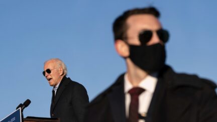 ST. PAUL, MN - OCTOBER 30: A U.S. Secret Service agents stands watch as Democratic presidential nominee Joe Biden speaks during a drive-in campaign rally at the Minnesota State Fairgrounds on October 30, 2020 in St. Paul, Minnesota. Biden is campaigning in Iowa, Wisconsin and Minnesota on Friday. (Photo by Drew Angerer/Getty Images)