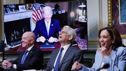 WASHINGTON, DC - AUGUST 03: (L-R) Homeland Security Secretary Alejandro Mayorkas, Attorney General Merrick Garland, and U.S. Vice President Kamala Harris laugh after U.S. President Joe Biden, appearing via teleconference, noted that Harris was speaking while 