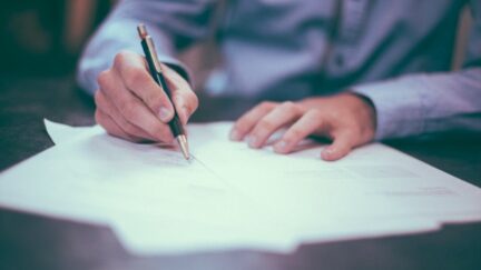 Man writes on paper