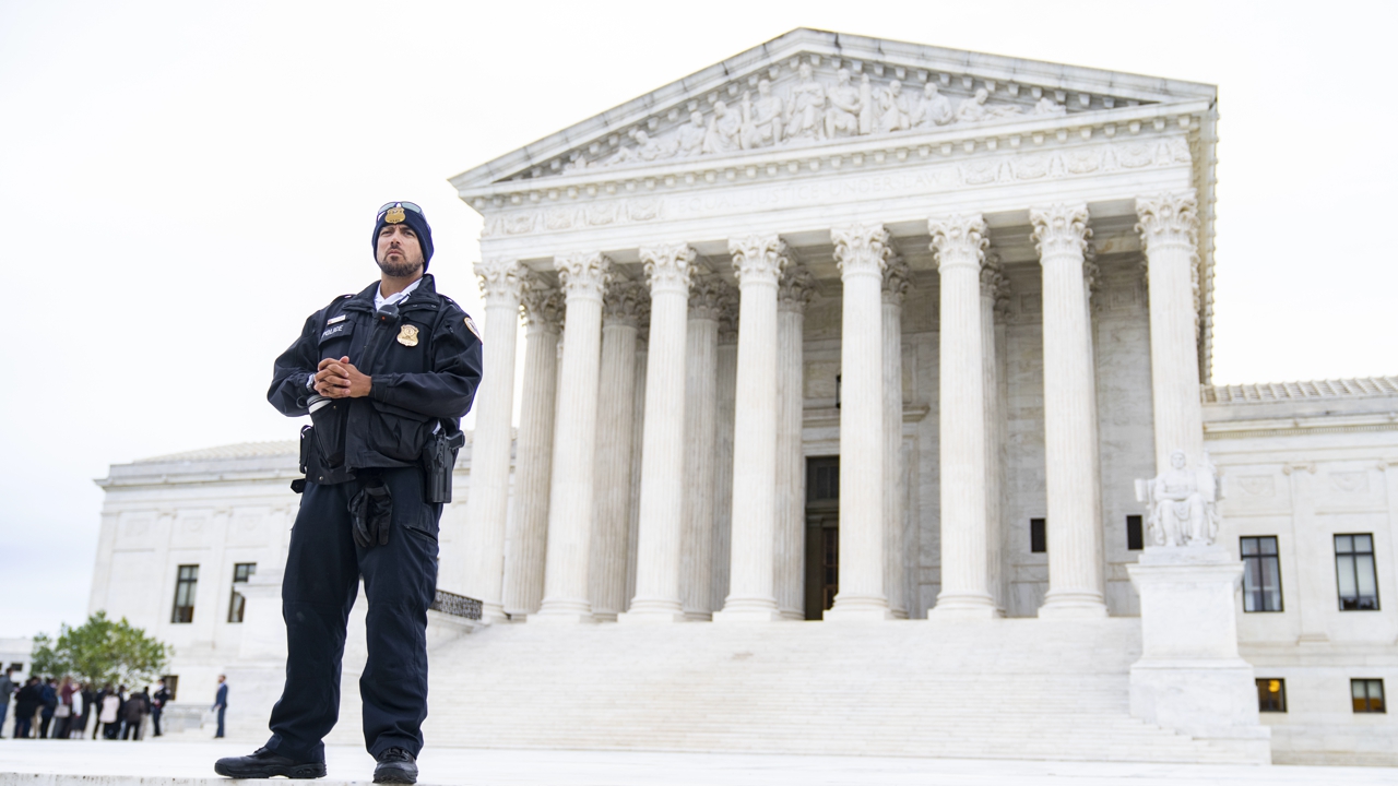 UNITED STATES - OCTOBER 3: A police officer is seen outside of the U.S. Supreme Court as it begins a new term on Monday, October 3, 2022. Members of the public were allowed in to hear the court's arguments that had been closed since March 2020 due to the coronavirus pandemic.