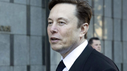 Elon Musk in a suit and tie