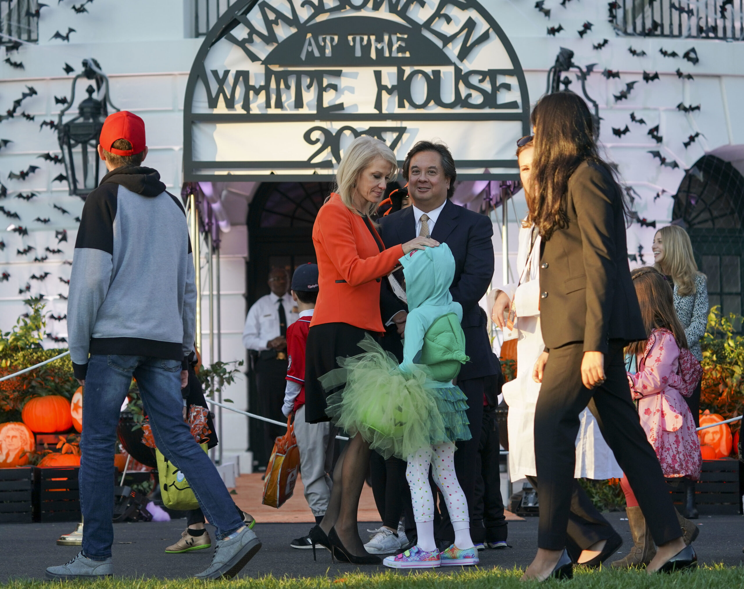 Counselor to the President Kellyanne Conway, center, and her husband George Conway, right, greet guests on the South Lawn of the White House in Washington during a Halloween event welcoming children from the Washington area and children of military families to trick-or-treat, Monday, Oct. 30, 2017.