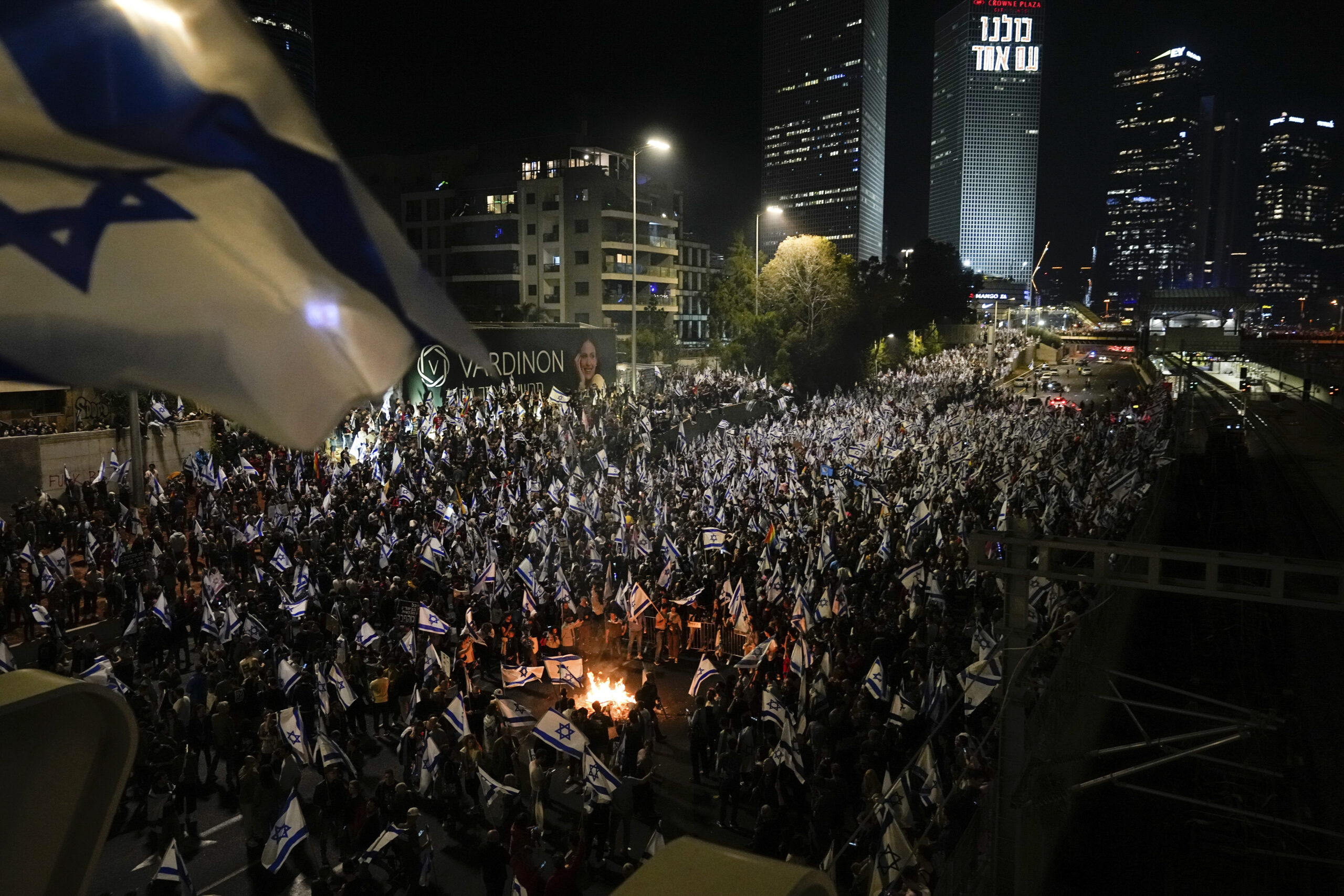 Israelis opposed to Prime Minister Benjamin Netanyahu's judicial overhaul plan set up bonfires and block a highway during a protest moments after the Israeli leader fired his defense minister, in Tel Aviv, Israel, Sunday, March 26, 2023. Defense Minister Yoav Gallant had called on Netanyahu to freeze the plan, citing deep divisions in the country and turmoil in the military.