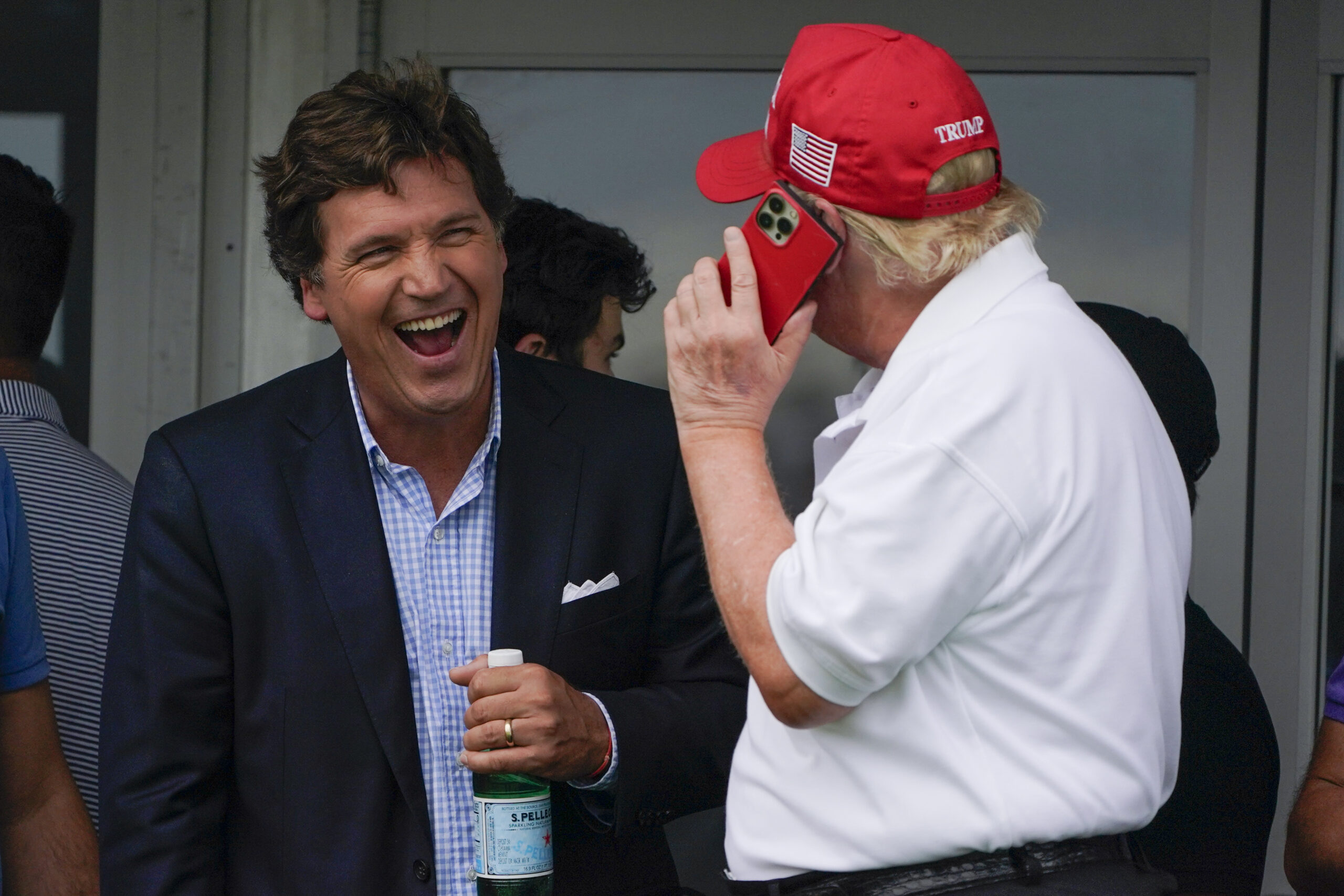 Tucker Carlson laughing with Donald Trump