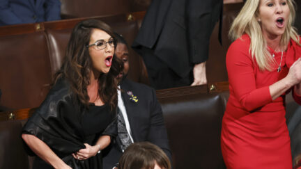 Rep. Lauren Boebert, R-Colo., left, and Rep. Marjorie Taylor Greene, R-Ga., right, scream 