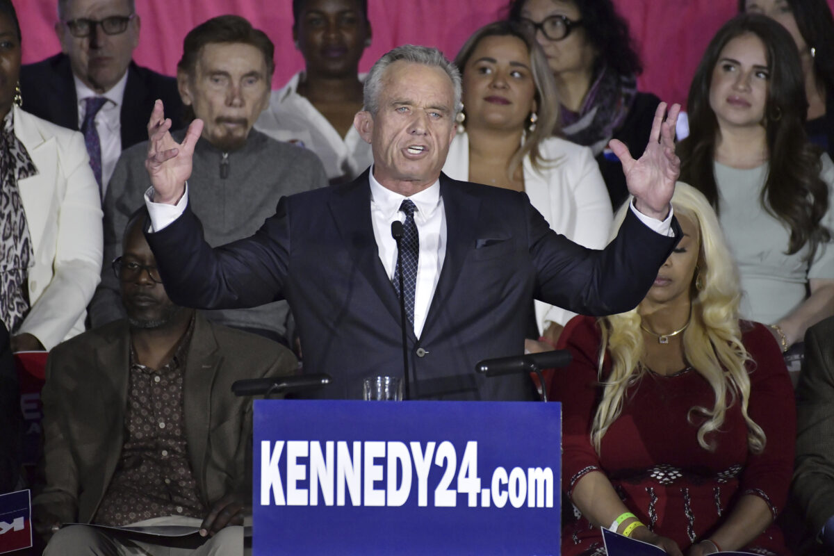 Democratic presidential candidate Robert F. Kennedy Jr. giving speech with his arms raised