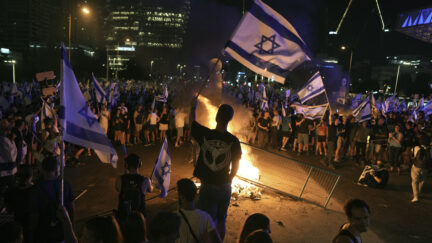 Demonstrators protest against plans by Prime Minister Benjamin Netanyahu's government to overhaul the judicial system, in Tel Aviv, Monday, July 24, 2023. Israeli lawmakers on Monday approved a key portion of Prime Minister Benjamin Netanyahu's divisive plan to reshape the country's justice system despite massive protests that have exposed unprecedented fissures in Israeli society.
