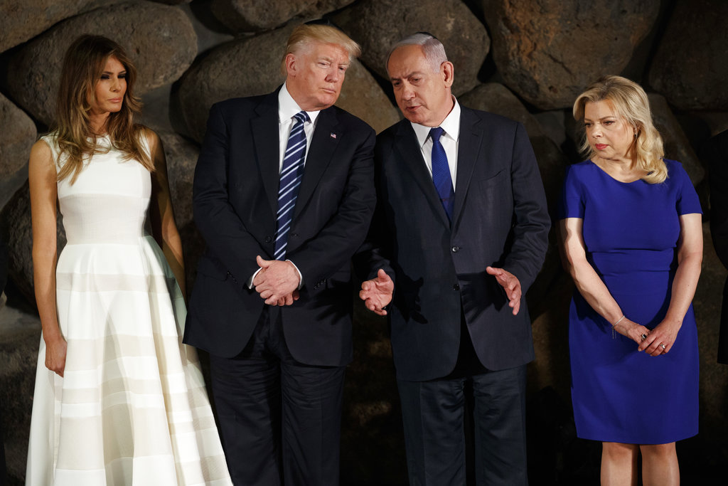 President Donald Trump talks with Israeli Prime Minister Benjamin Netanyahu during a ceremony to lay a wreath at Yad Vashem to honor the victims of the holocaust, Tuesday, May 23, 2017, in Jerusalem. From left, first lady Melania Trump, Trump, Netanyahu, and Sara Netanyahu. 