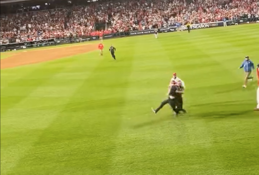 WATCH: Fan tackled hard by security guard on field during Phillies game