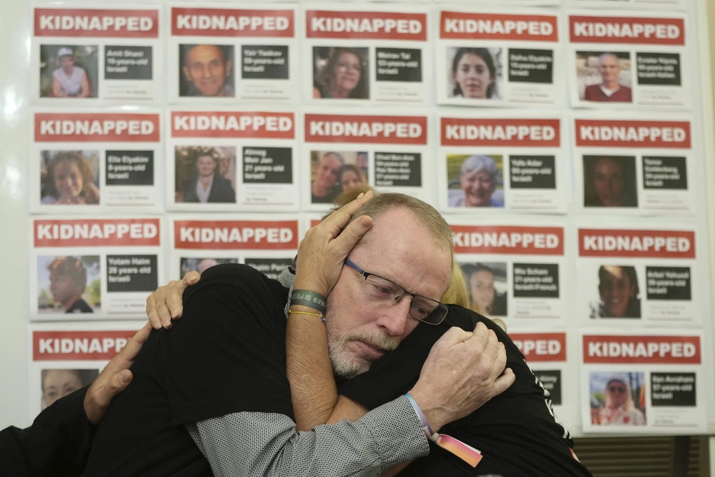 Orit Meir, right, mother of Israel hostage Almog Meir is comforted by Thomas Hand, left, father of 9 year old Irish-Israeli hostage Emily Hand, both taken after the Oct. 7 assault by Hamas militants, attend a news conference at the Israel Embassy in London, Monday, Nov. 20, 2023. More than 200 Israelis and foreigners were taken hostage on Oct. 7 after Hamas militants infiltrated Israel. 