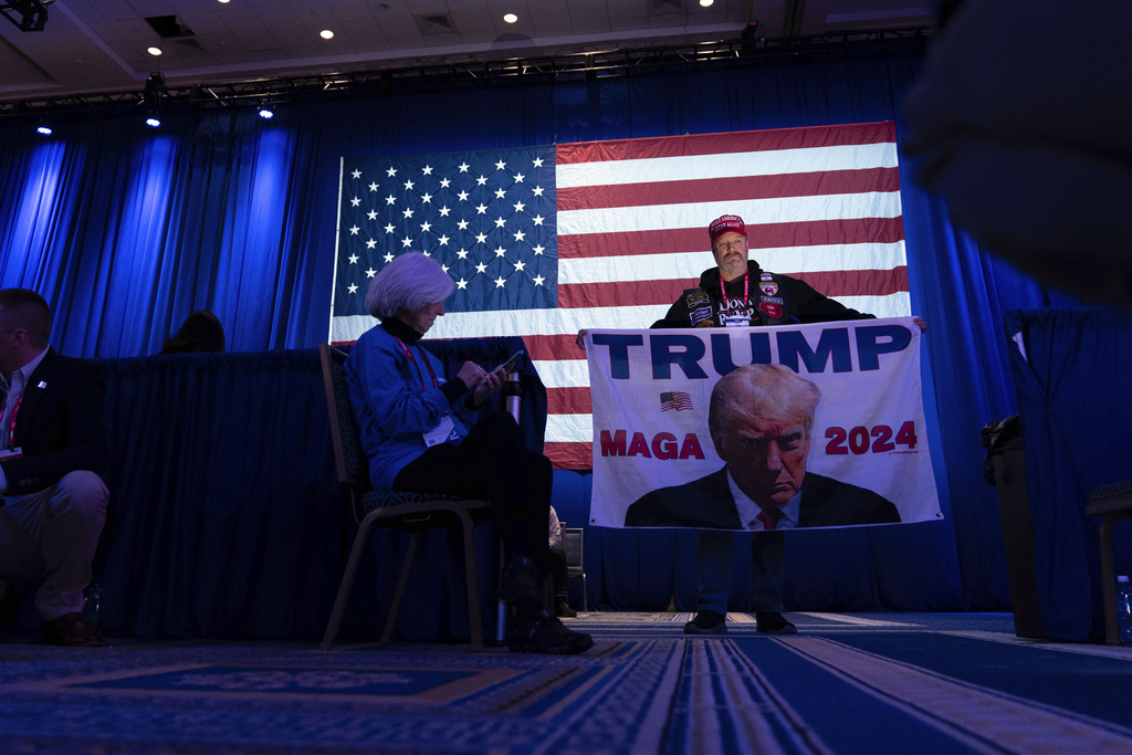A supporter of Republican presidential candidate former President Donald Trump hold up a sign during the Conservative Political Action Conference, CPAC 2024, at the National Harbor in Oxon Hill, Md., Thursday, Feb. 22, 2024.