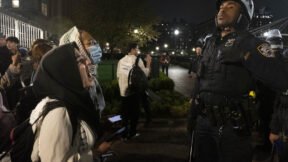 Pro-Palestine student activists face off with New York Police Department officers during a raid on Columbia University's campus at the request of Columbia University President Minouche Shafik on Tuesday evening, April 30, 2024 in New York. NYPD officers, including those from the police department's Strategic Response Group, arrested approximately 100 people as they dismantled encampments and removed individuals occupying Hamilton Hall.
