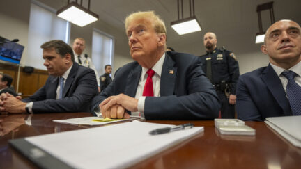 Former President Donald Trump, center, sits with lawyers while he attends his trial at Manhattan Criminal Court, Tuesday, May 28, 2024, in New York City. (Steven Hirsch/New York Post via AP, Pool)