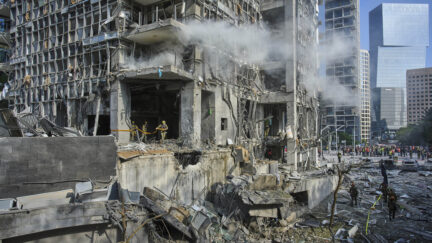Rescue workers and military personnel inspect the site of a direct hit from an Iranian missile strike in Ramat Gan, Israel, Thursday, June 19, 2025.
