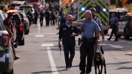 Law enforcement officers gather outside the Annunciation Church