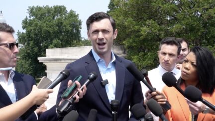 Ossoff surrounded by reporters with microphones