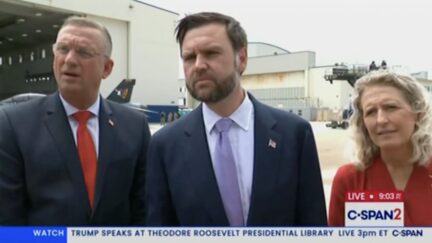 Vance on the tarmac answering questions from the press after speaking to American troops