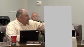 Keith Ervin leans in and tells the girl, whose image is blocked, 
