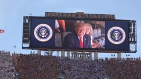 trump on billboard waving to crowd at tennessee game